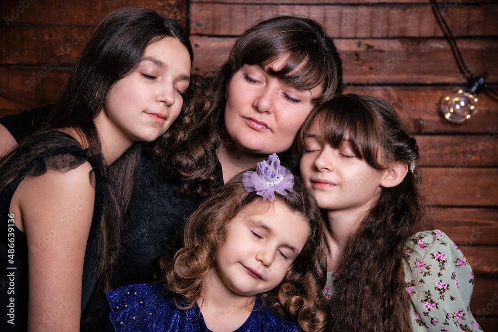 Portrait of a young family. Mom and three daughters.