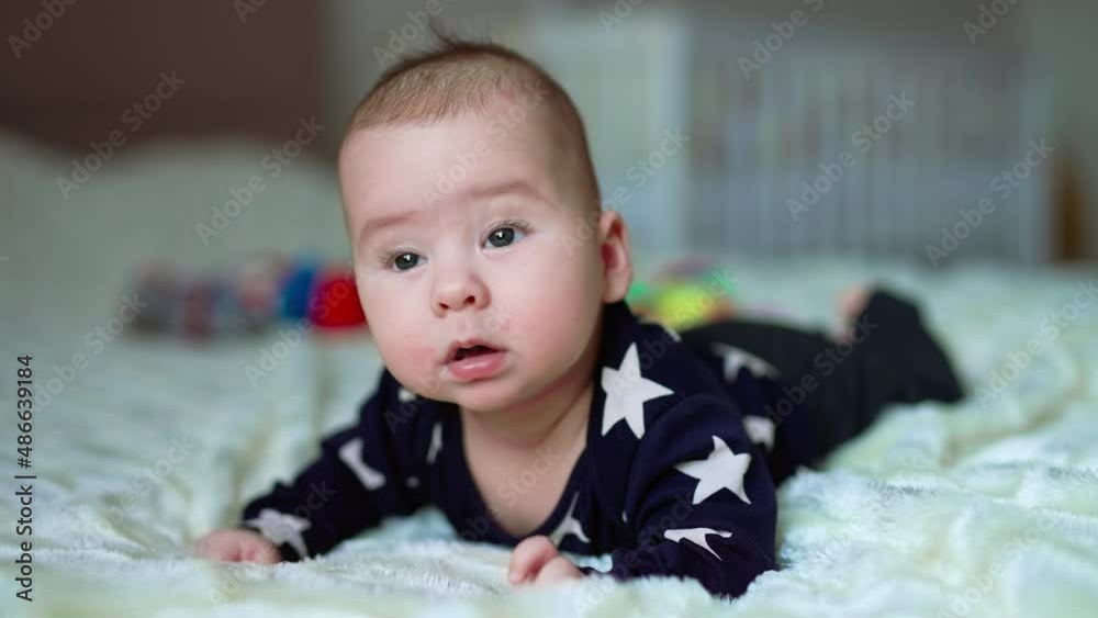 Small cute baby on the bed. Funny little child portrait smilling. Small cute baby on the bed. Funny little child portrait smilling.