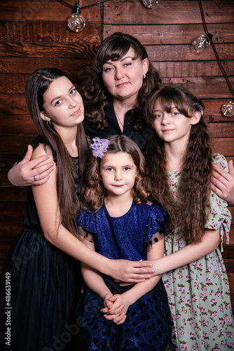 Portrait of a young family. Mom and three daughters.