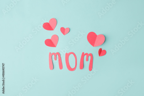 Obraz na płótnie Mothers day message on paper cut hearts over blue background, simple diy creative idea, banner, greeting card for mom w salonie