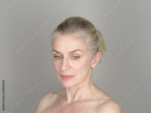 Thoughtful adult model on gray