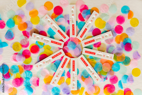 Circle of at-home covid tests on colorful dots