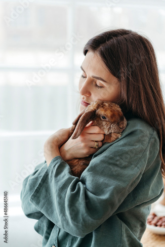 Woman with pet in hands. photo