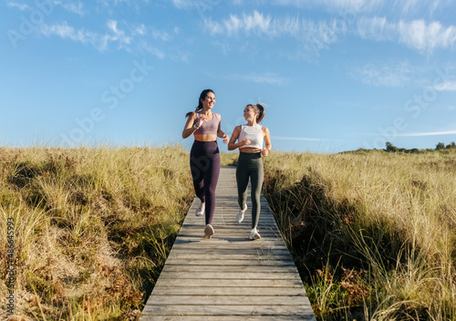 Two young fitness women training photo