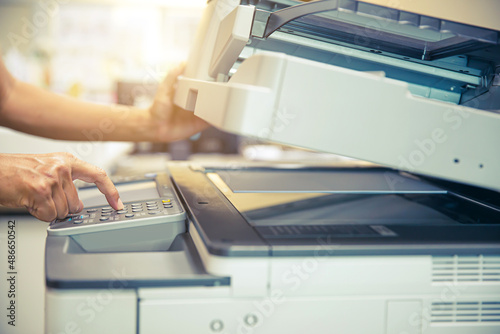 Copier printer, Close up hand office man press copy button on panel to using the copier or photocopier machine for scanning document printing a sheet paper and xerox photocopy.