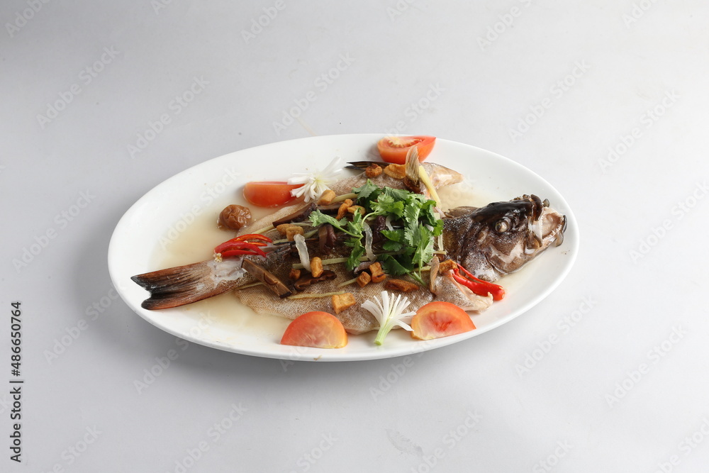 teo chew steamed whole fresh red grouper fish in salted vegetable tomato sauce chinese banquet halal seafood menu on white background
