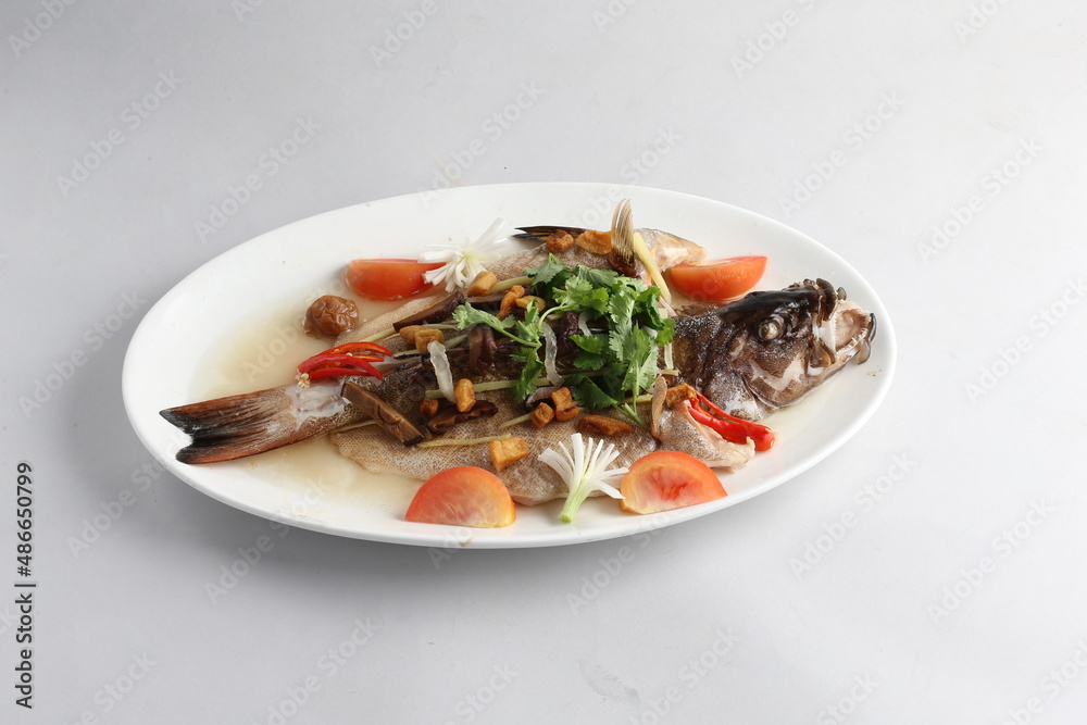 teo chew steamed whole fresh red grouper fish in salted vegetable tomato sauce chinese banquet halal seafood menu on white background teo chew steamed whole fresh red grouper fish in salted vegetable tomato sauce chinese banquet halal seafood menu on white background