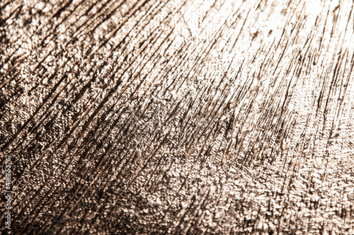area of radially crumpled gold patina, flare effect, short focus