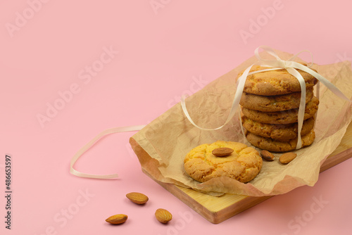 Cookies with almond, homemade almond cookies on a pink background, copy space photo