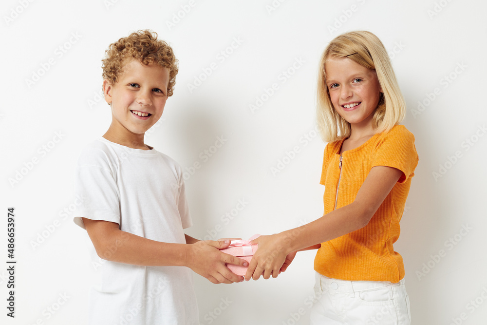 picture of positive boy and girl fun birthday gift surprise isolated background unaltered picture of positive boy and girl fun birthday gift surprise isolated background unaltered