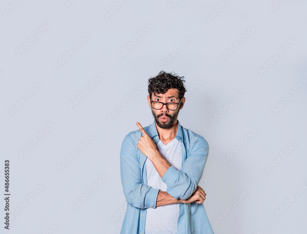 Shocked young man with new idea, shocked guy pointing finger up Shocked young man with new idea, shocked guy pointing finger up