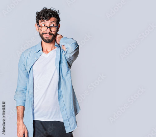 Tableau sur toile Latin young man with awkward face isolated on white background, Concept of an aw