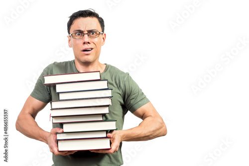 Puzzled male student showing pile of books