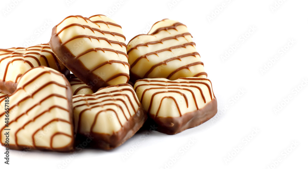 A bunch of heart - shaped chocolates on a white background . A bunch of heart - shaped chocolates on a white background .