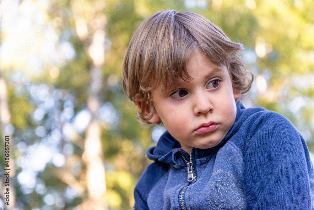portrait of a serious little boy outdoors portrait of a serious little boy outdoors