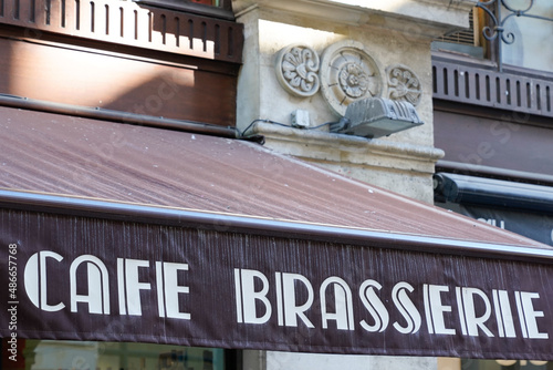 cafe brasserie french sign text means coffee brewery on entrance restaurant in city street storefront building pub entrance photo