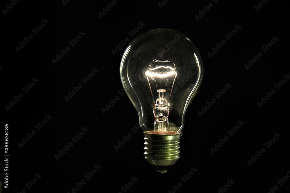 tungsten light bulb on black background tungsten light bulb on black background