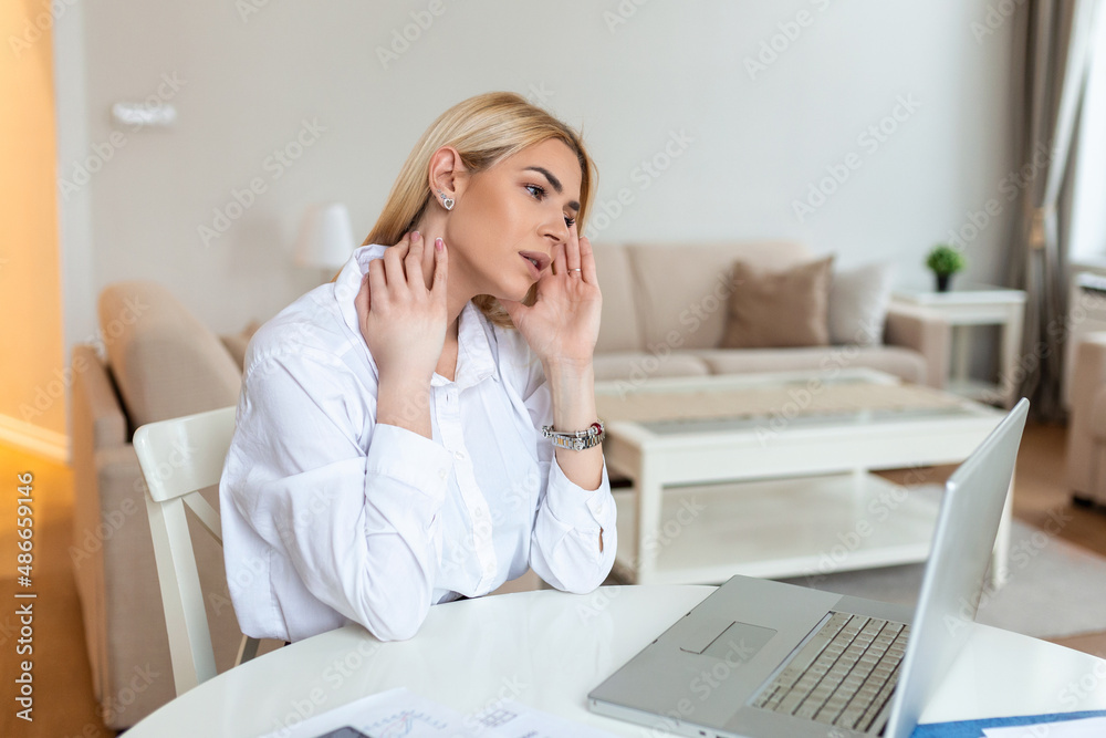 Young frustrated woman working at office desk in front of laptop suffering from chronic daily headaches, treatment online, appointing to a medical consultation, electromagnetic radiation, sick pay Young frustrated woman working at office desk in front of laptop suffering from chronic daily headaches, treatment online, appointing to a medical consultation, electromagnetic radiation, sick pay