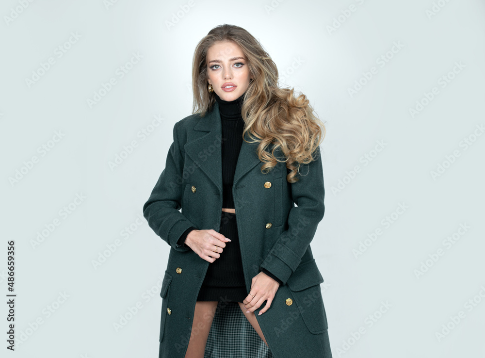 Vogue female coat. Beautiful stylish girl in fashion dress posing isolated on studio background. Beautiful woman wearing vogue clothes. Fashion photo. Vogue female coat. Beautiful stylish girl in fashion dress posing isolated on studio background. Beautiful woman wearing vogue clothes. Fashion photo.
