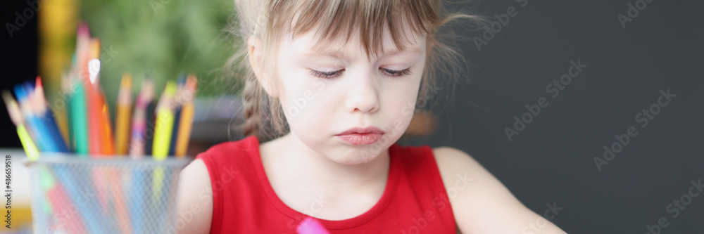 Little girl drawing at table with colored pencils Little girl drawing at table with colored pencils