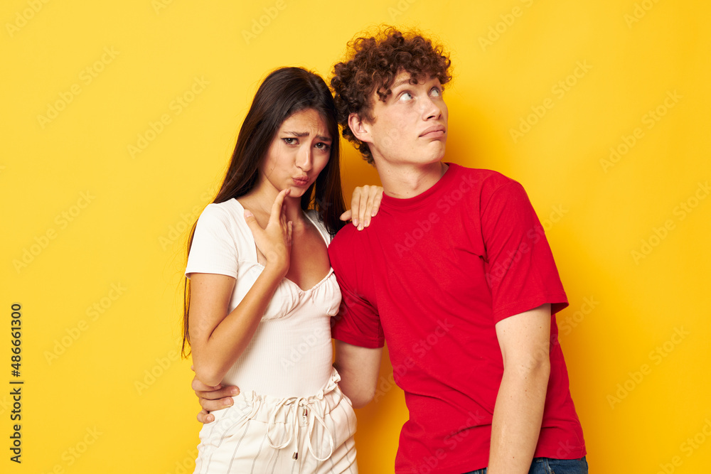 portrait of a man and a woman together posing emotions close-up yellow background unaltered portrait of a man and a woman together posing emotions close-up yellow background unaltered