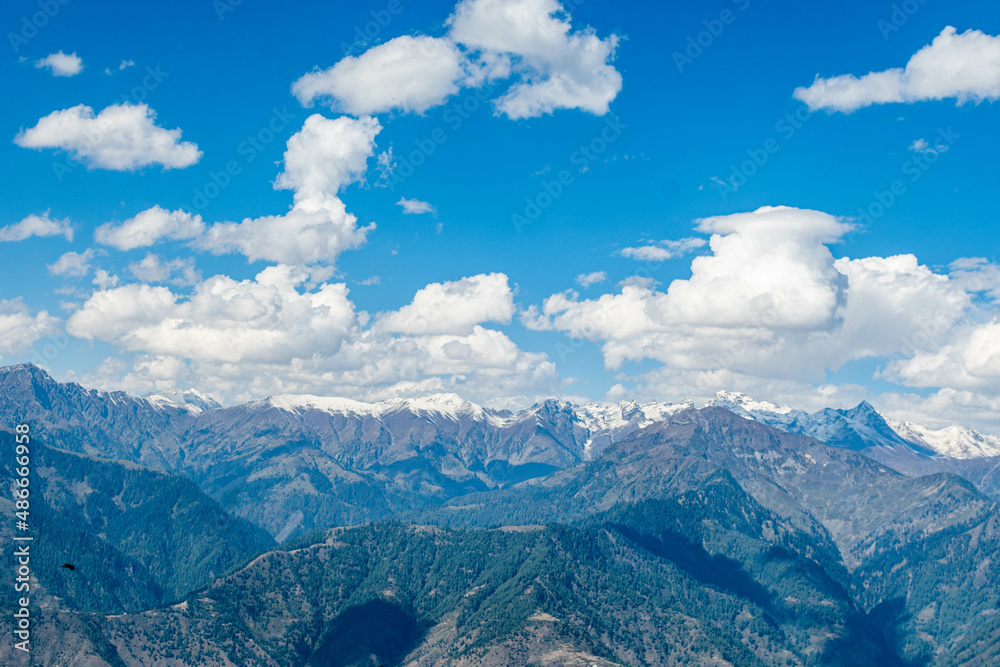 Blue Sky with full of White Clouds, and green trees, and the mountain is full of greeneries, a magical view of north Pakistan, Shogran National Park. 