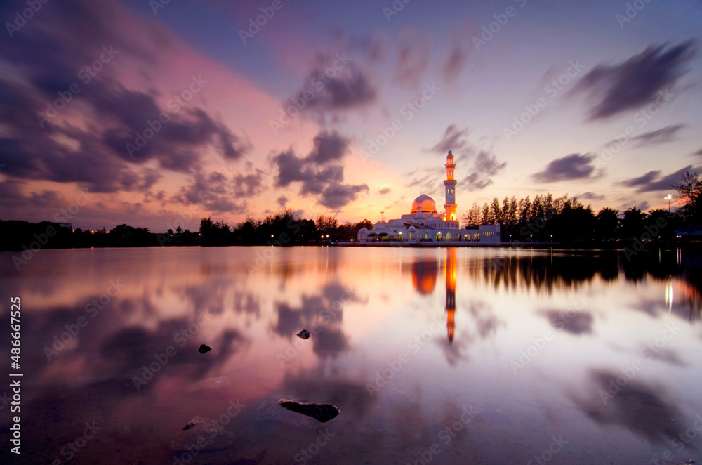 Scenery of a mosque with a lake and beautiful sunset colors