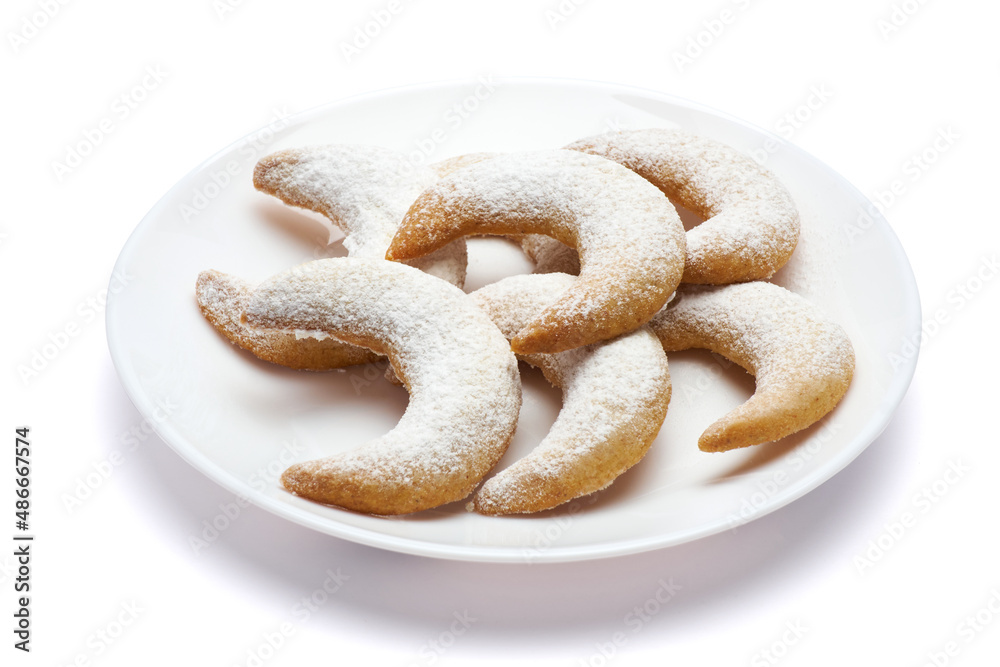 Traditional German or Austrian Vanillekipferl vanilla kipferl cookies on a plate isolated on white background