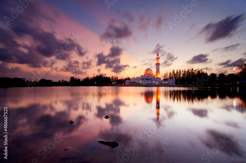 Scenery of a mosque with a lake and beautiful sunset colors © nadzlanimages
