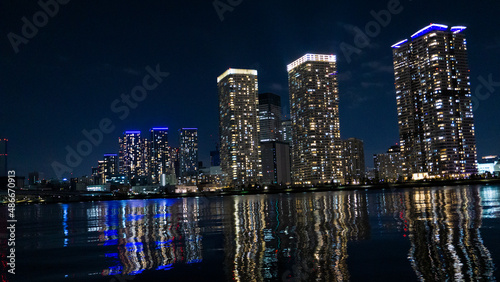 Night view of a high-rise condominium along an urban river_08