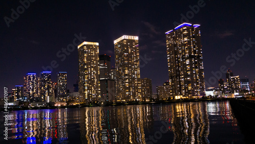 Night view of a high-rise condominium along an urban river_09