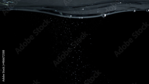 Soda water liquid splashing bubbles drop in black background represent sparkling and refreshing