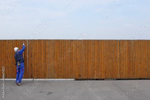 wooden fence with worker