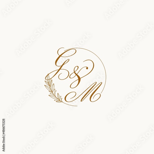 Initials GM wedding monogram logo with leaves and elegant circular lines