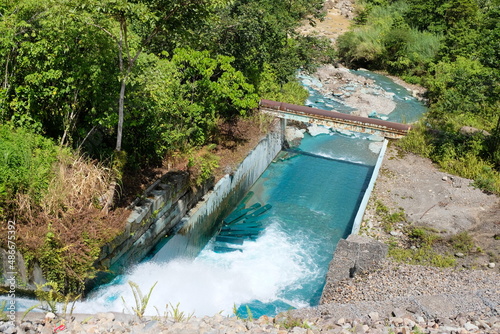 Vivid blue waterway river at Panguna copper and gold mine in Bougainville, Papua New Guinea © Adam Constanza