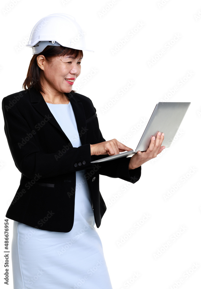 Portrait studio closeup cutout isolated shot of Asian professional senior female engineer architect model in formal suit and safety helmet standing smiling holding laptop computer on white background Portrait studio closeup cutout isolated shot of Asian professional senior female engineer architect model in formal suit and safety helmet standing smiling holding laptop computer on white background