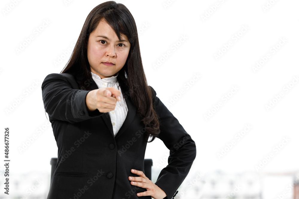 Portrait studio shot of Asian angry moody crazy aggressive frowning face female businesswoman manager model in formal suit standing look at camera pointing finger at you warning admonishing advising Portrait studio shot of Asian angry moody crazy aggressive frowning face female businesswoman manager model in formal suit standing look at camera pointing finger at you warning admonishing advising