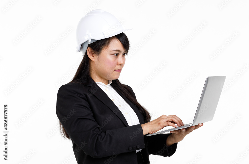 Portrait studio cutout isolated closeup shot Asian young female engineer architect in formal suit with safety hardhat helmet smiling look at camera holding typing laptop computer on white background Portrait studio cutout isolated closeup shot Asian young female engineer architect in formal suit with safety hardhat helmet smiling look at camera holding typing laptop computer on white background