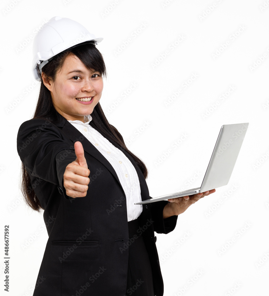 Portrait studio cutout isolated closeup shot Asian young female engineer architect in formal suit with safety hardhat helmet smiling look at camera holding typing laptop computer on white background Portrait studio cutout isolated closeup shot Asian young female engineer architect in formal suit with safety hardhat helmet smiling look at camera holding typing laptop computer on white background