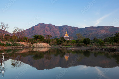 Big Buddha Statue in Wat Khao Wongphrachan will have an annual Buddha Festival during February with beautiful water reflections at Lopburi province, Thailand