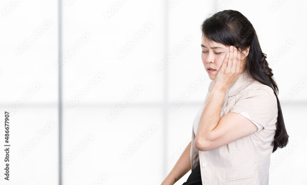 Asian stressed depressed tired exhausted worried frowning face female businesswoman secretary standing holding two hands squeezing face forgetting important customer appointment in company office Asian stressed depressed tired exhausted worried frowning face female businesswoman secretary standing holding two hands squeezing face forgetting important customer appointment in company office