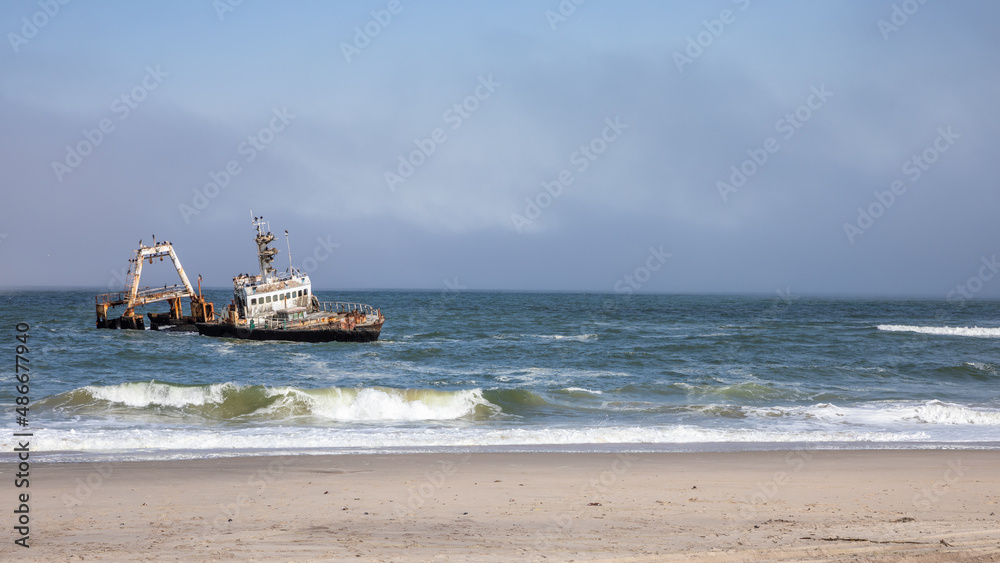 Abandoned shipwreck of the stranded Zeila vessel at the Skeleton Coast near Swakopmund in Namibia, Africa, with many cormorants sitting on the wreck. Abandoned shipwreck of the stranded Zeila vessel at the Skeleton Coast near Swakopmund in Namibia, Africa, with many cormorants sitting on the wreck.