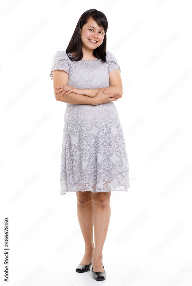 Portrait studio cutout isolated full body shot of Asian young happy trendy female model in beautiful gray lace dress standing posing holding hand on waist smiling look at camera on white background Portrait studio cutout isolated full body shot of Asian young happy trendy female model in beautiful gray lace dress standing posing holding hand on waist smiling look at camera on white background