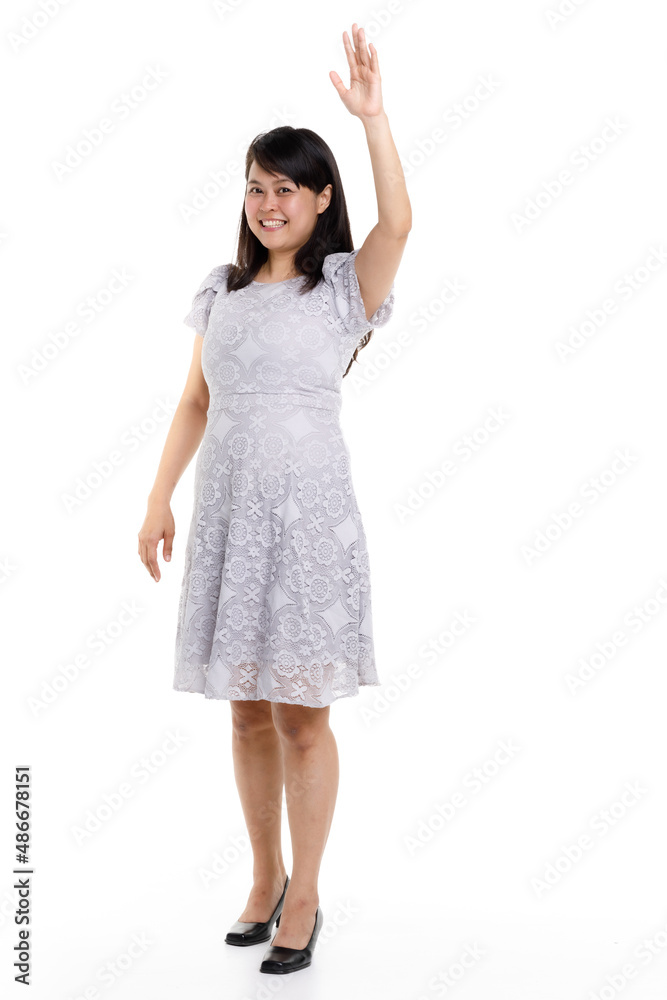 Portrait studio cutout isolated full body shot of Asian young happy trendy female model in beautiful gray lace dress standing posing holding hand on waist smiling look at camera on white background Portrait studio cutout isolated full body shot of Asian young happy trendy female model in beautiful gray lace dress standing posing holding hand on waist smiling look at camera on white background