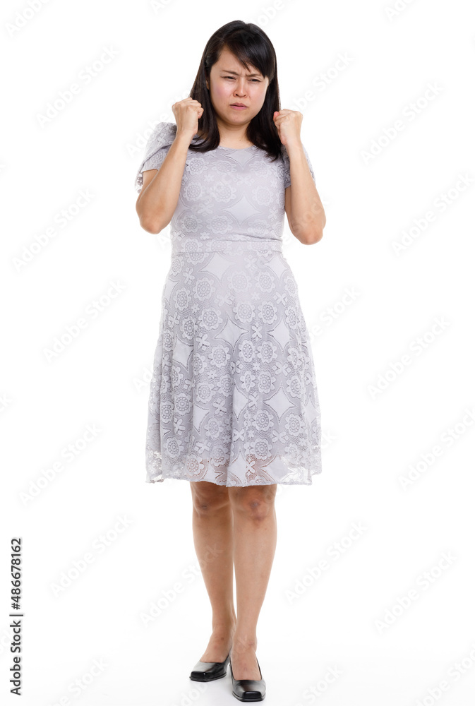 Portrait studio cutout isolated full body shot of Asian young happy trendy female model in beautiful gray lace dress standing posing holding hand on waist smiling look at camera on white background Portrait studio cutout isolated full body shot of Asian young happy trendy female model in beautiful gray lace dress standing posing holding hand on waist smiling look at camera on white background