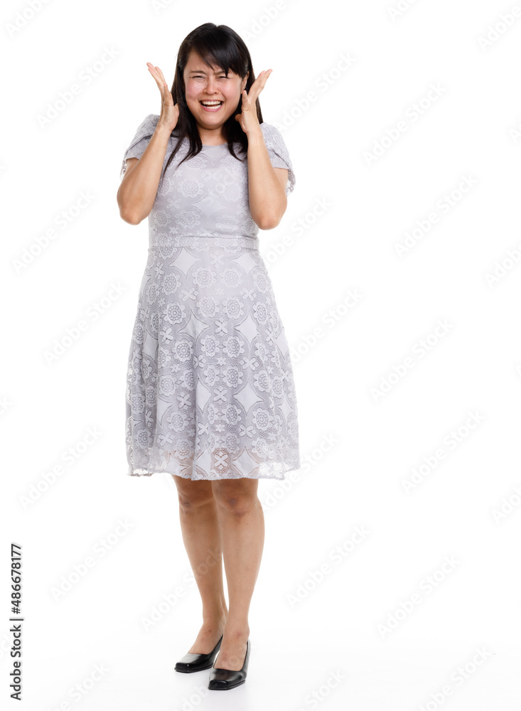 Portrait studio cutout isolated full body shot of Asian young happy trendy female model in beautiful gray lace dress standing posing holding hand on waist smiling look at camera on white background Portrait studio cutout isolated full body shot of Asian young happy trendy female model in beautiful gray lace dress standing posing holding hand on waist smiling look at camera on white background