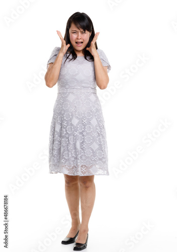 Portrait studio cutout isolated full body shot of Asian young happy trendy female model in beautiful gray lace dress standing posing holding hand on waist smiling look at camera on white background