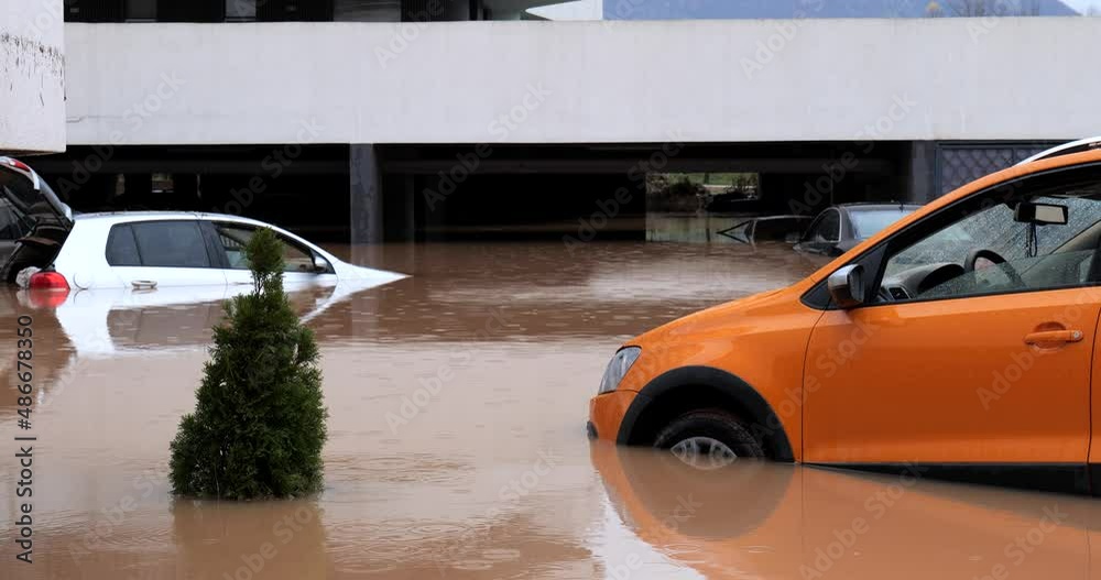 Torrential rain causes flash floods in the city area. Cars under water ...