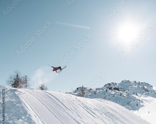 skier doing tricks in the air in snowpark