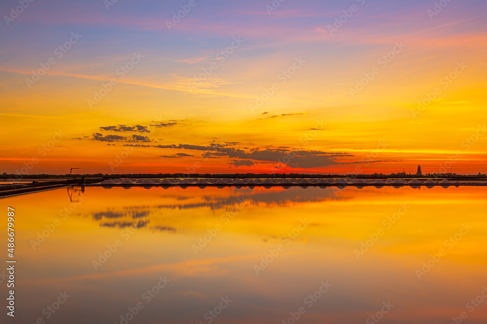 Fototapeta premium Sunset salt farming (Naklua) in the coastal, Phetchaburi provinces of Thailand, Landscape
